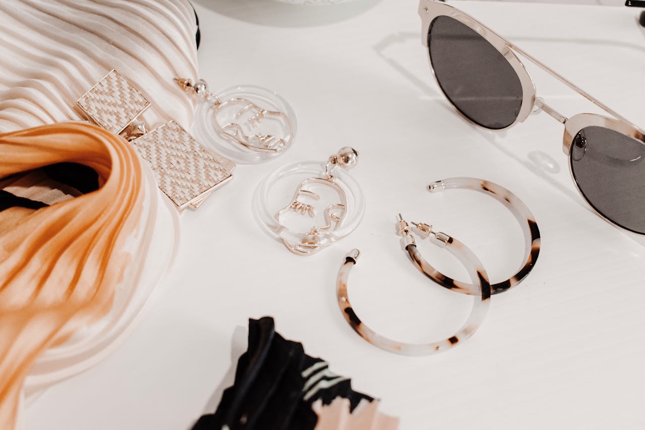 Mastering the First Impression: Your intriguing post title goes here Stylish flat lay of modern fashion accessories including earrings, scarf, and sunglasses.